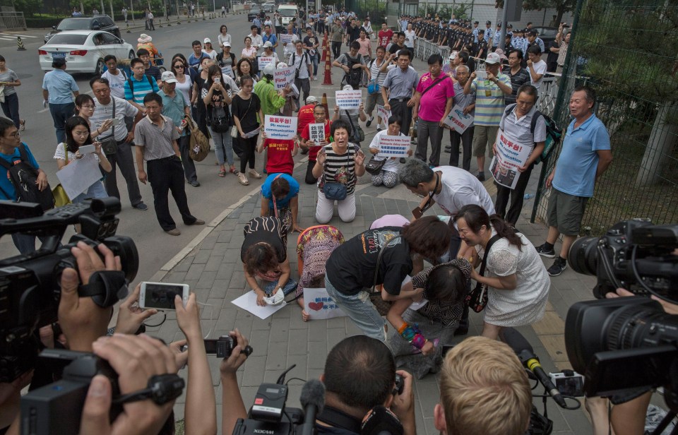 Relatives of passengers missing on Malaysian Airlines flight MH370 during protests in 2015