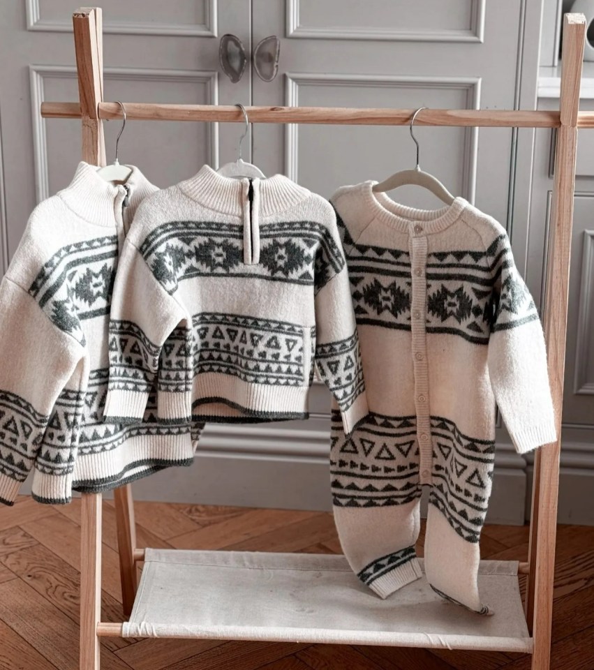 two sweaters are hanging on a rack and the words tomorrow are above them