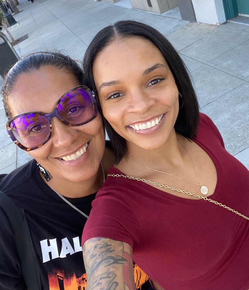 a woman wearing a shirt that says hawaii smiles next to another woman