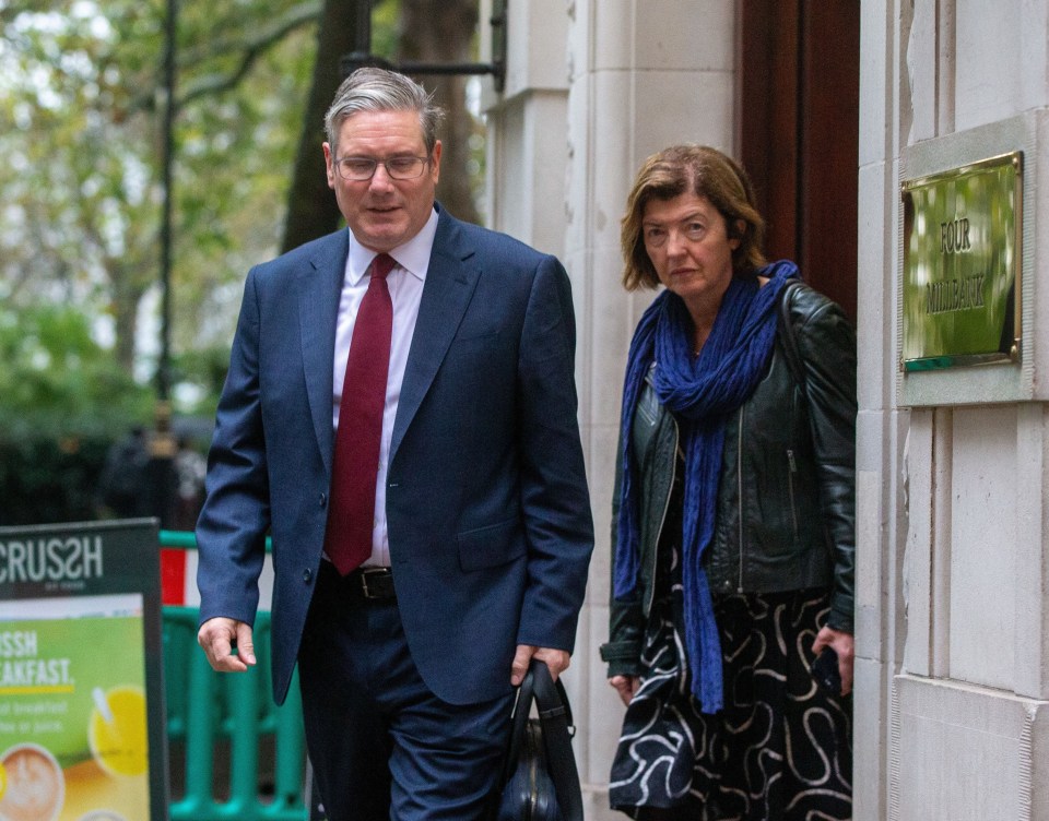 a man and woman are walking in front of a crus2h sign