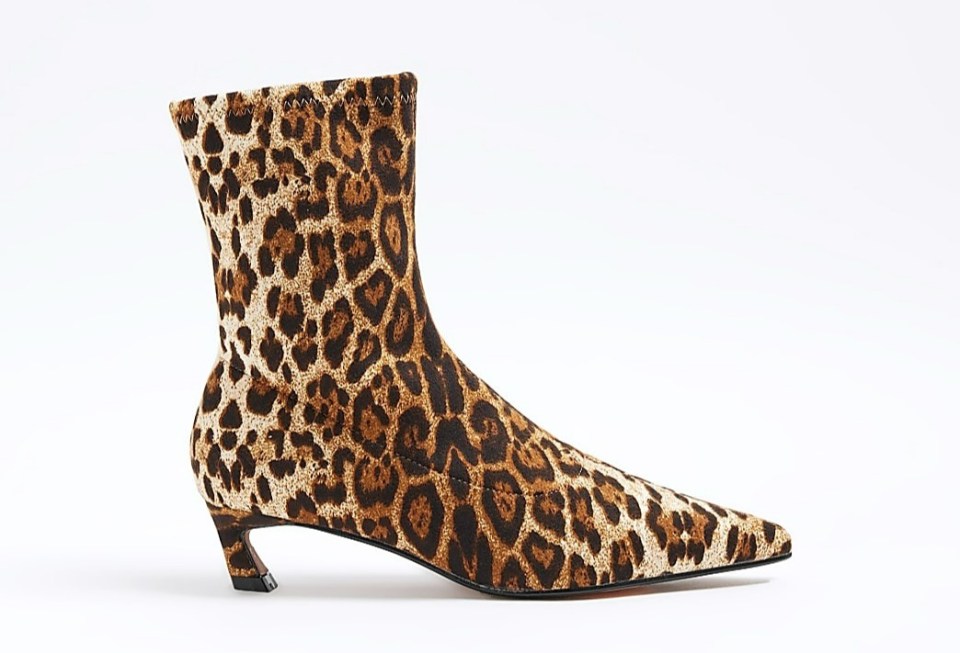 a pair of leopard print boots on a white background