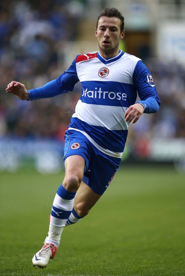 a soccer player wearing a blue and white uniform that says waitrose