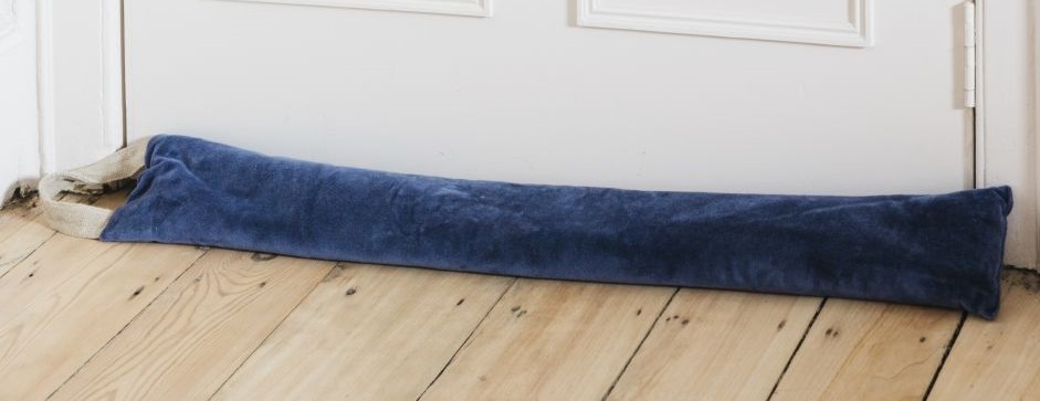 a blue door stopper on a wooden floor next to a door