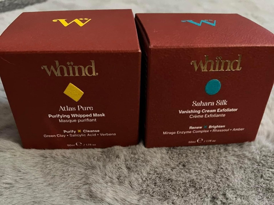 two boxes of whind products sit on a furry surface