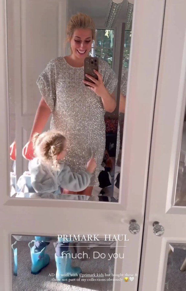 a woman is taking a picture of herself and a little girl in front of a mirror that says primark haul much do you