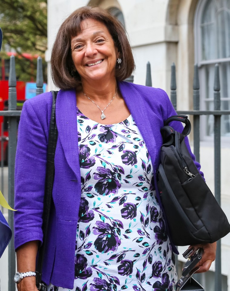 two women standing next to each other one wearing a purple jacket