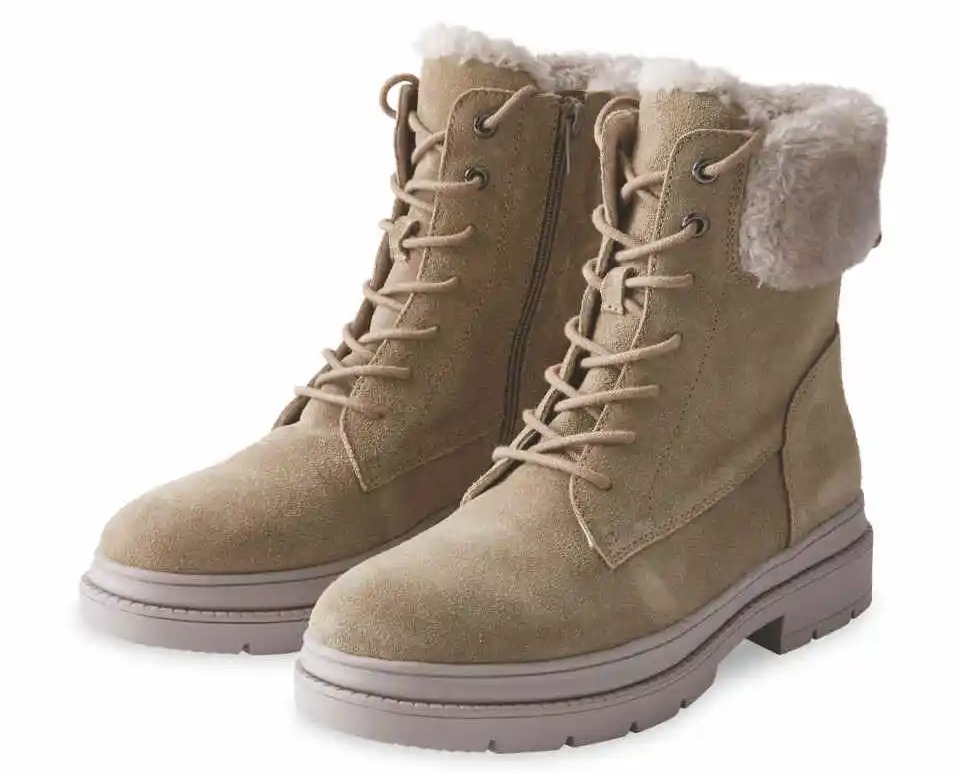 a pair of tan lace up boots with a furry cuff