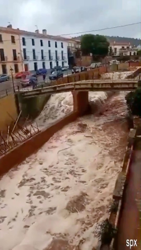 A road is turned into a gushing rapid in the extreme weather