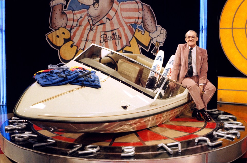 Original host Jim sits on the speedboat prize for Bullseye