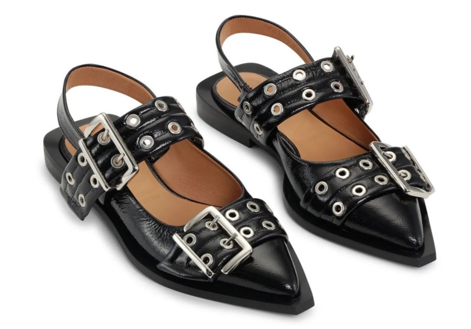 a pair of black shoes with silver buckles on them