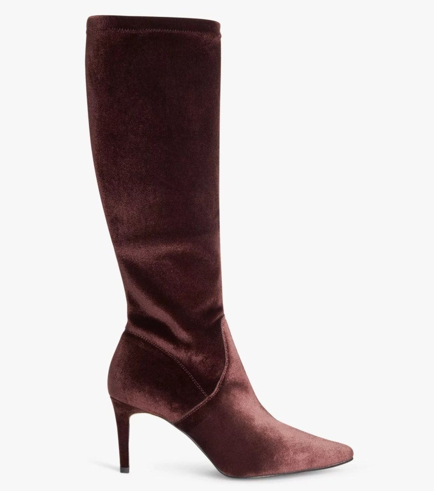 a pair of burgundy velvet knee high boots with a pointed toe