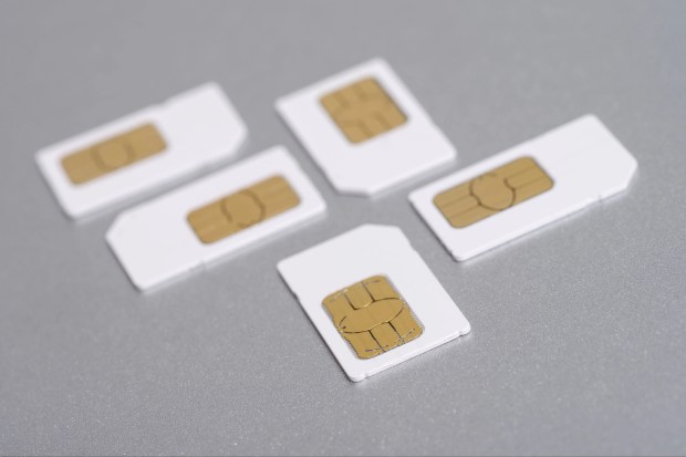 four different sized sim cards are lined up on a table