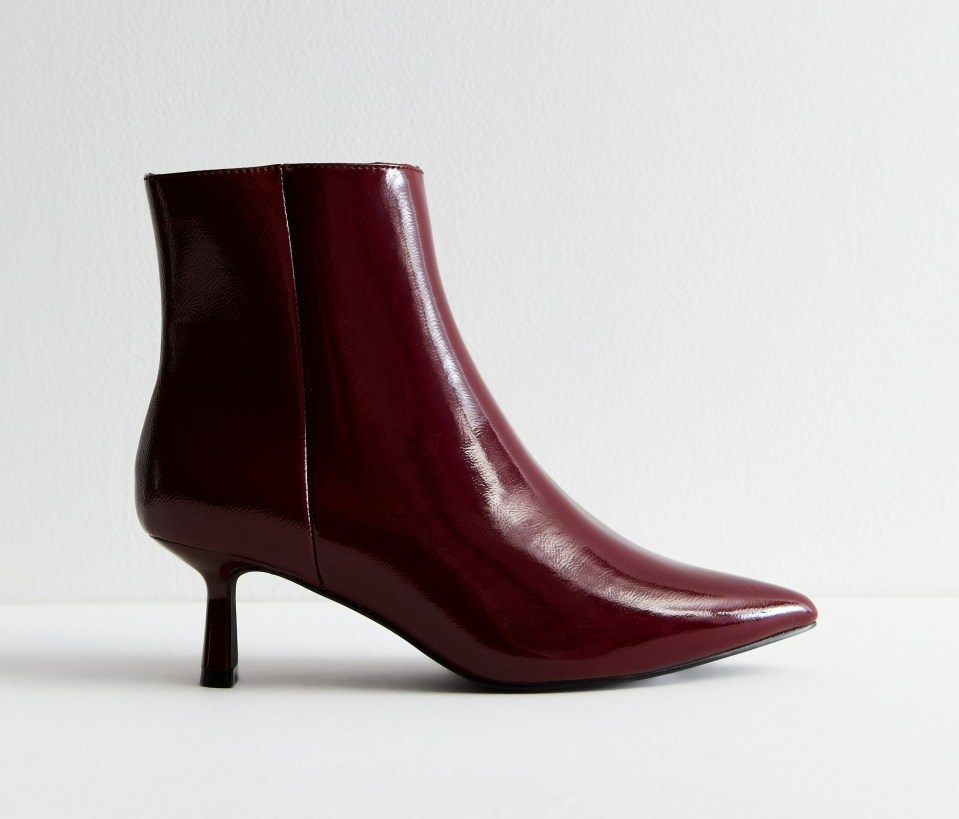 a pair of burgundy boots on a white background