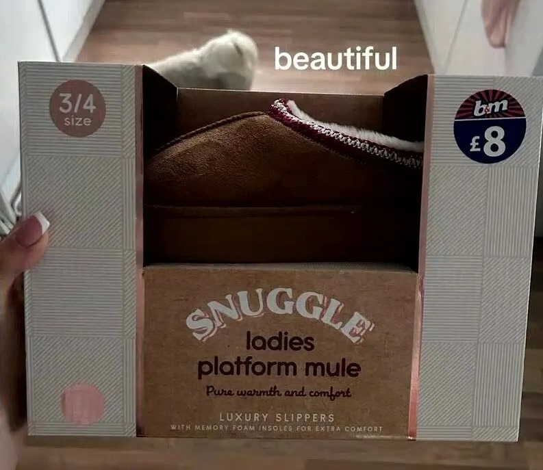 a person is holding a box of snuggle ladies platform mule slippers