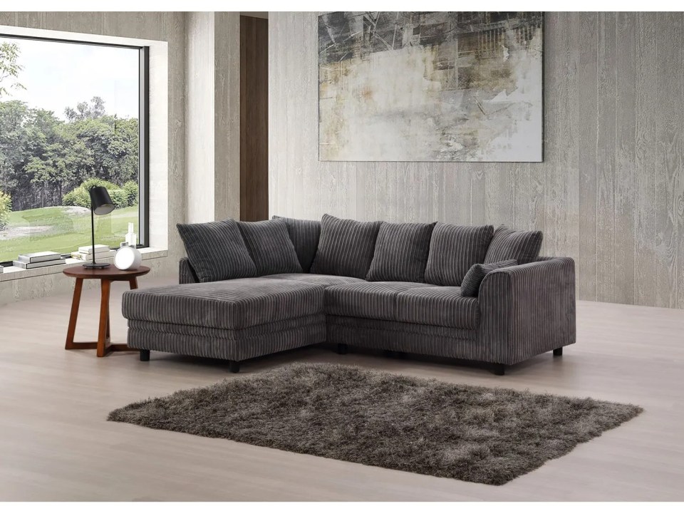 a living room with a sectional couch and a rug