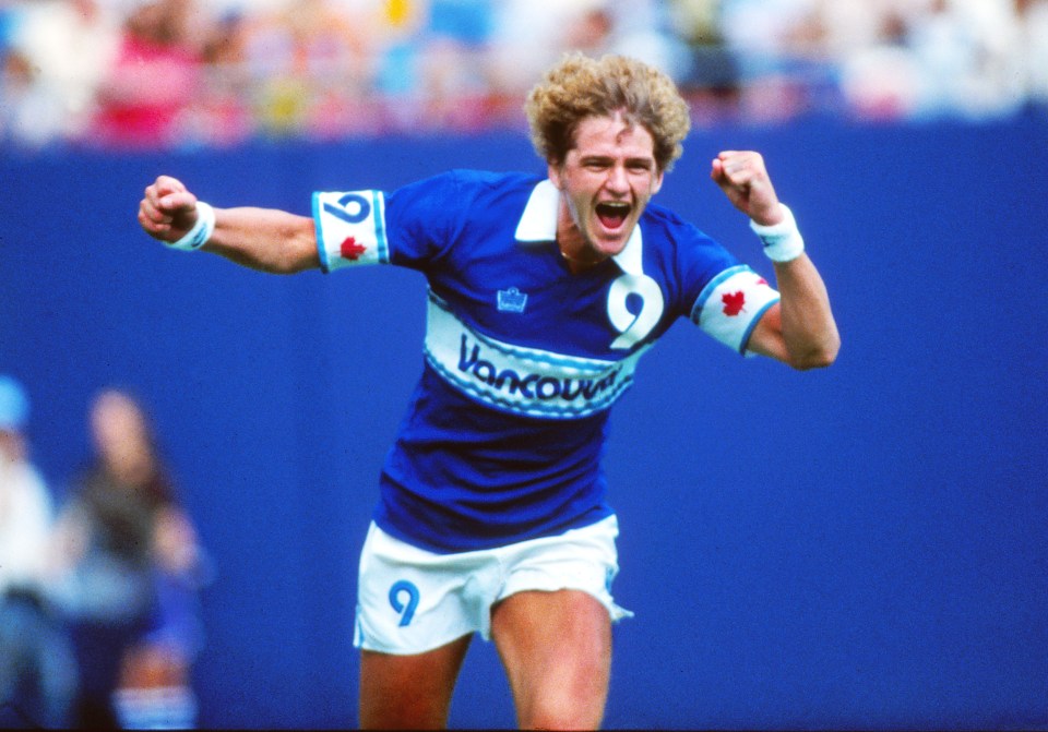 a man in a blue vancouver jersey celebrates