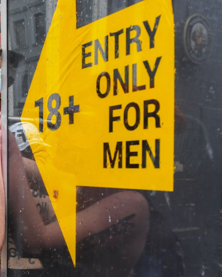 a sign that says entry only for men on it