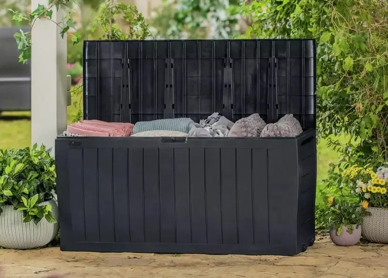 a black storage box is filled with clothes and rocks