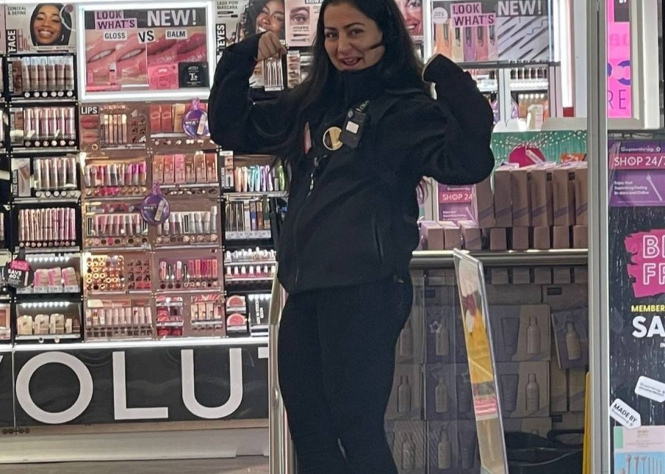 a woman standing in front of a makeup revolution store