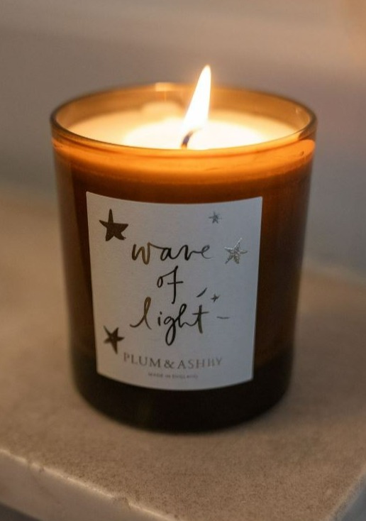 a candle that says wave of light on it