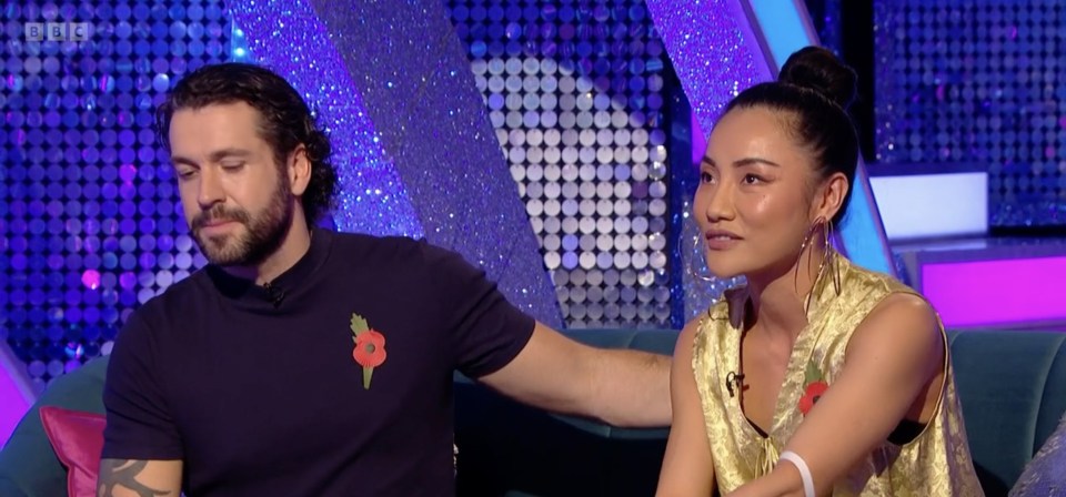 a man and a woman are sitting next to each other on a couch and the screen says bbc