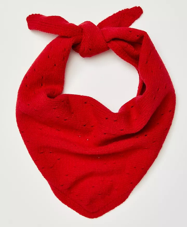 a red scarf with holes in it is tied in a knot