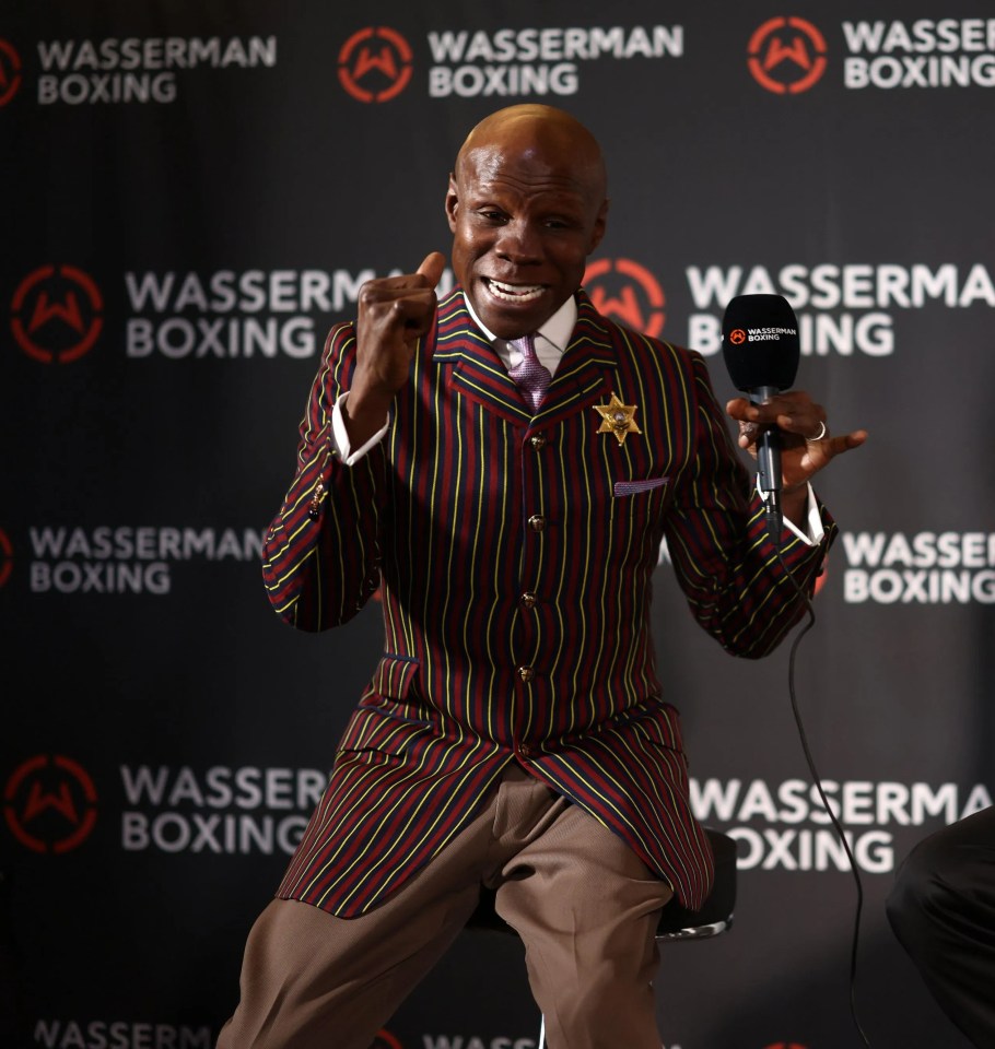 two men are sitting in front of a wall that says wasserman boxing