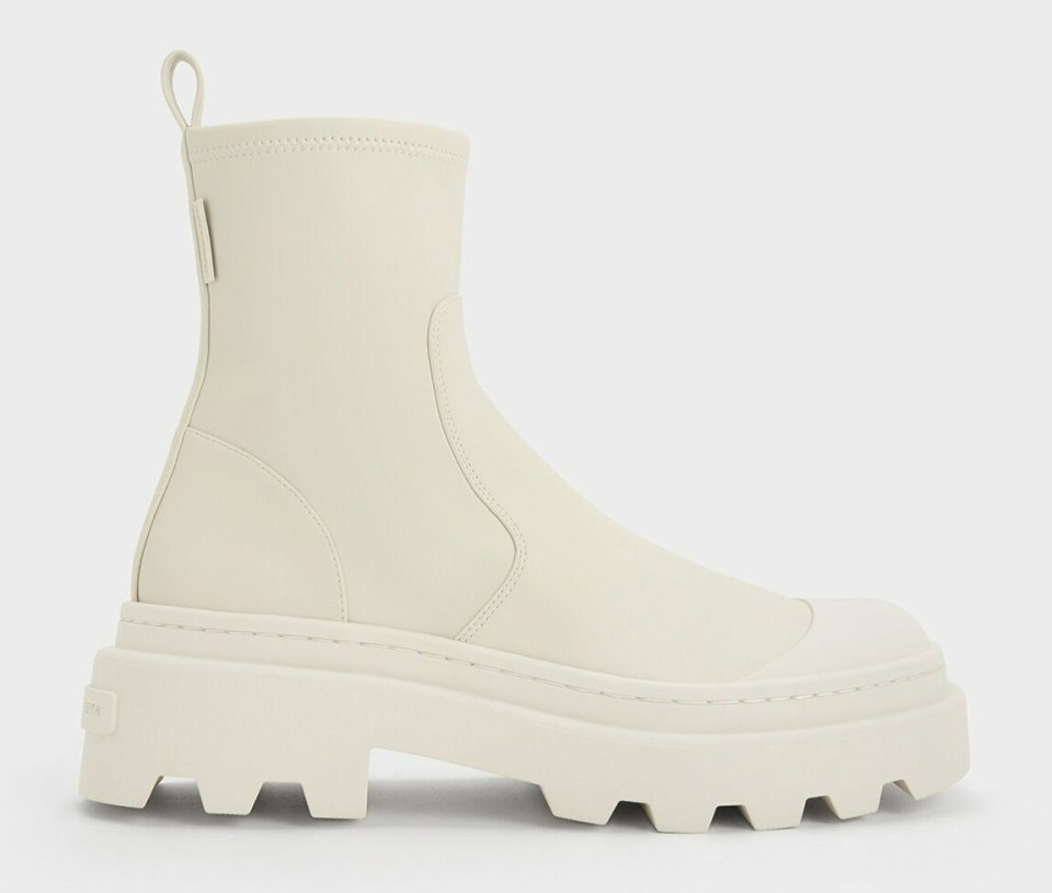 a pair of white boots on a white background