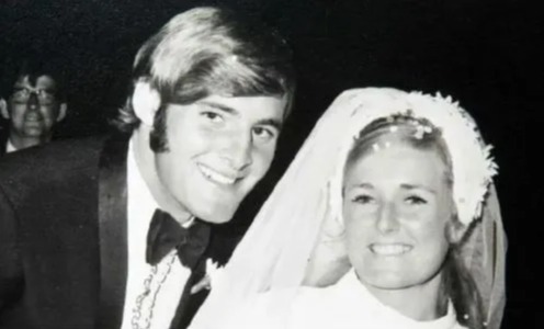 a black and white photo of a bride and groom on their wedding day .