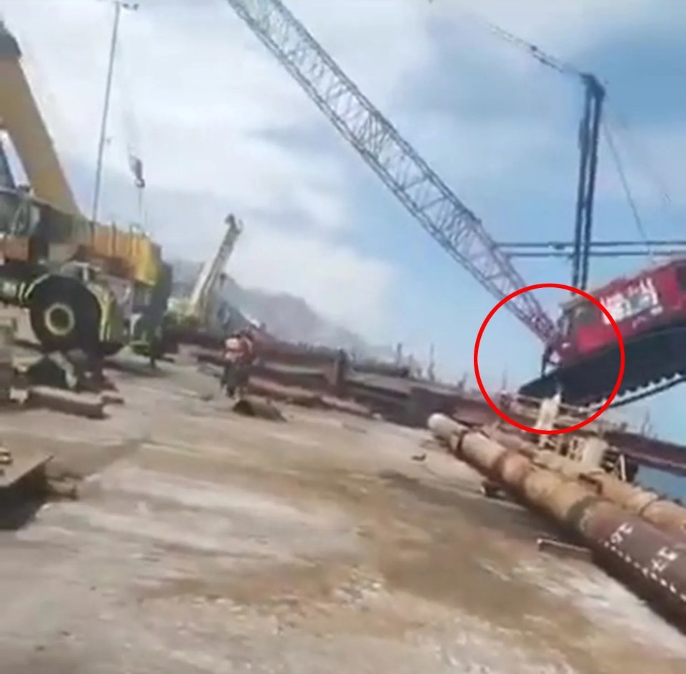 The terrifying moment a falling crane nearly crushed a worker has been caught