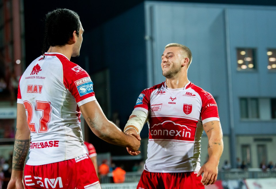 two soccer players shaking hands with one wearing a jersey that says connexion