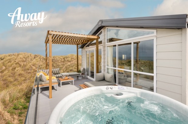 an ad for away resorts shows a hot tub on a balcony