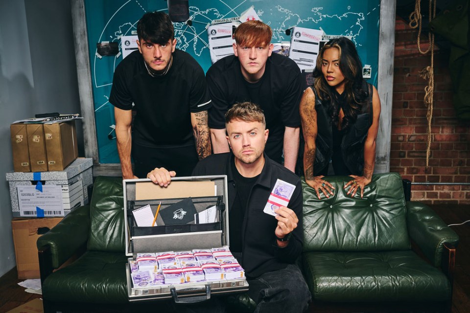 a group of people standing around a man holding a briefcase full of money