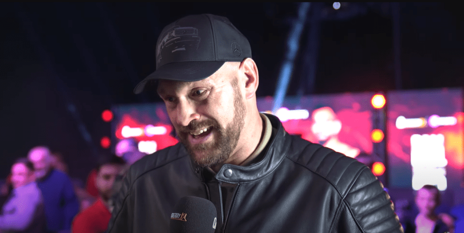 a man wearing a hat and a jacket with a microphone that says espn on it