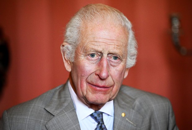 a close up of a man wearing a suit and tie