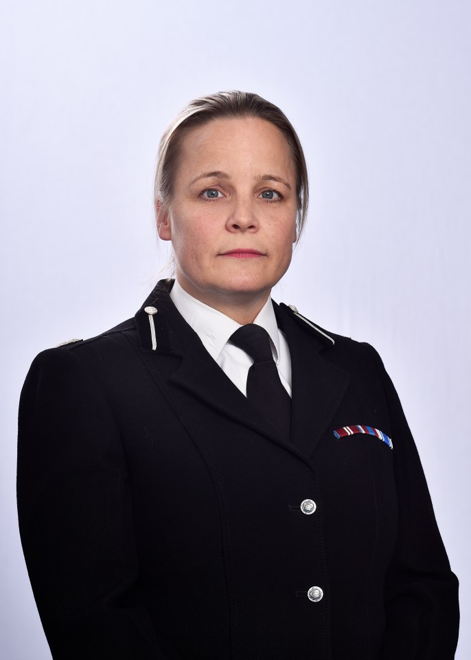 a woman in a military uniform stands in front of a white background