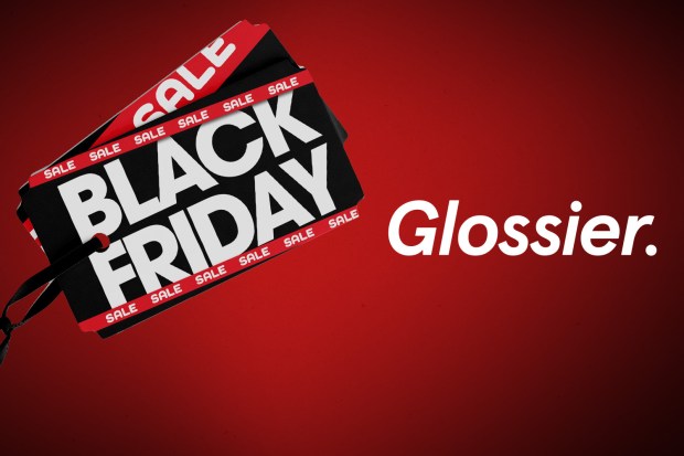 a black friday sale sign next to a glossier logo