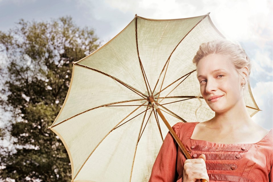 a woman in a red dress is holding an umbrella