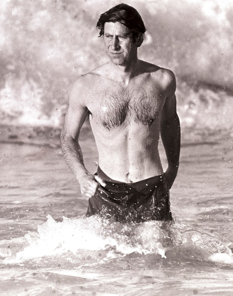 a man without a shirt is standing in the water