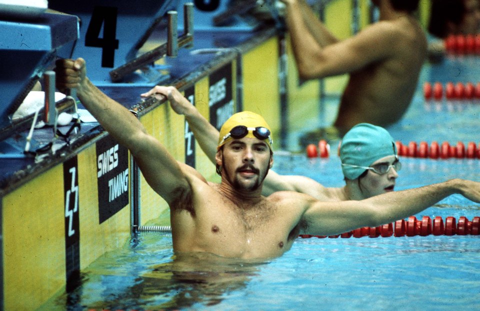 a man in a swimming pool with the number 4 in the background