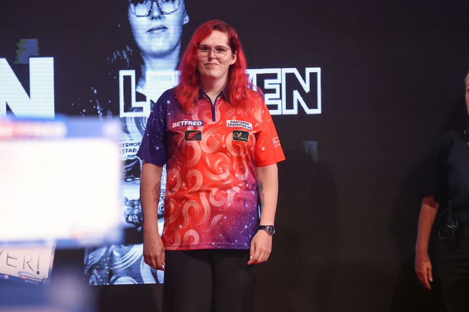 a woman with red hair is wearing a betfred shirt