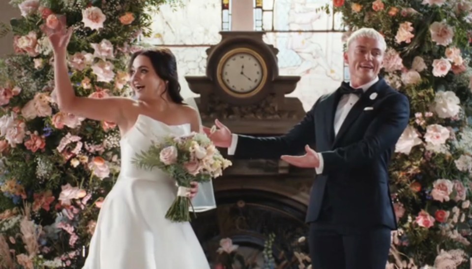 a bride and groom celebrate their wedding in front of a clock