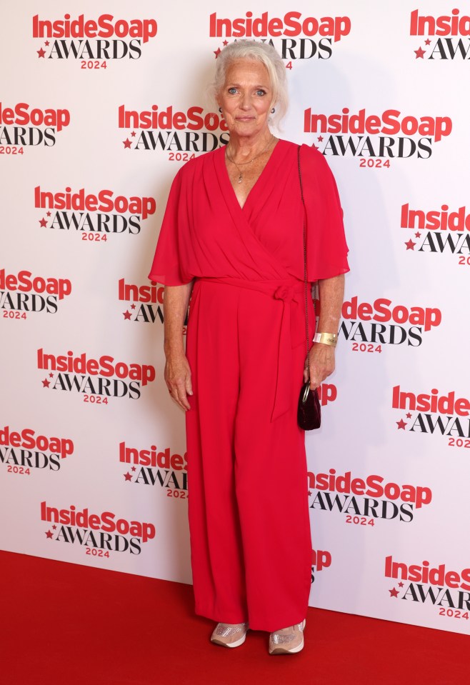 a woman in a red jumpsuit is on the red carpet at the inside soap awards