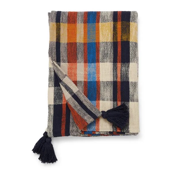 a colorful plaid blanket with tassels on a white background