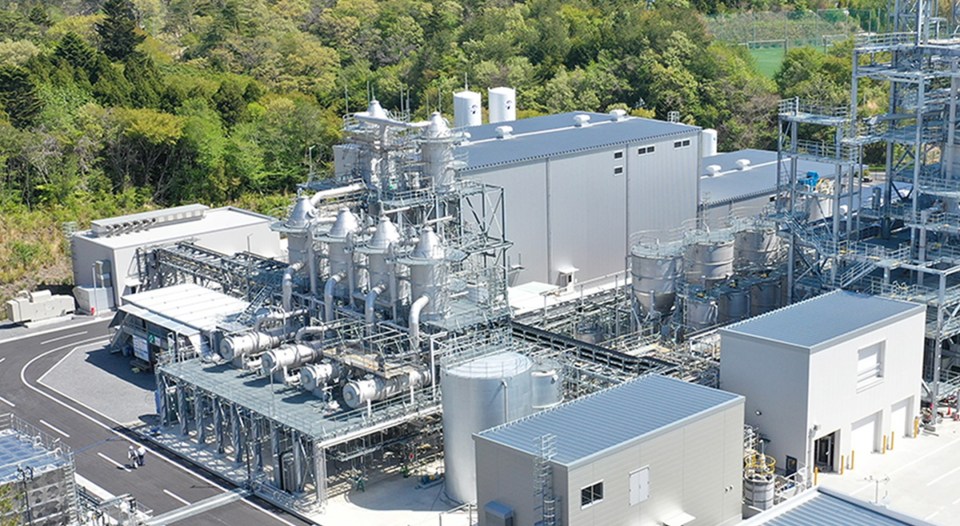 a large industrial plant with a large white building in the middle