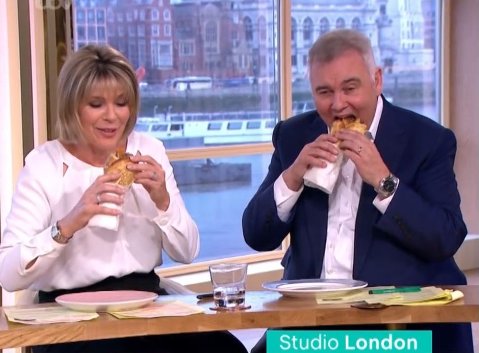 a man and a woman are sitting at a table with a sign that says studio london