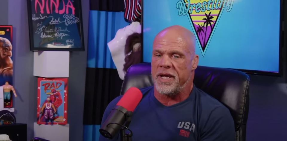 a bald man sitting in front of a microphone wearing a shirt that says usa