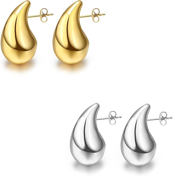 a pair of gold and silver earrings on a white background