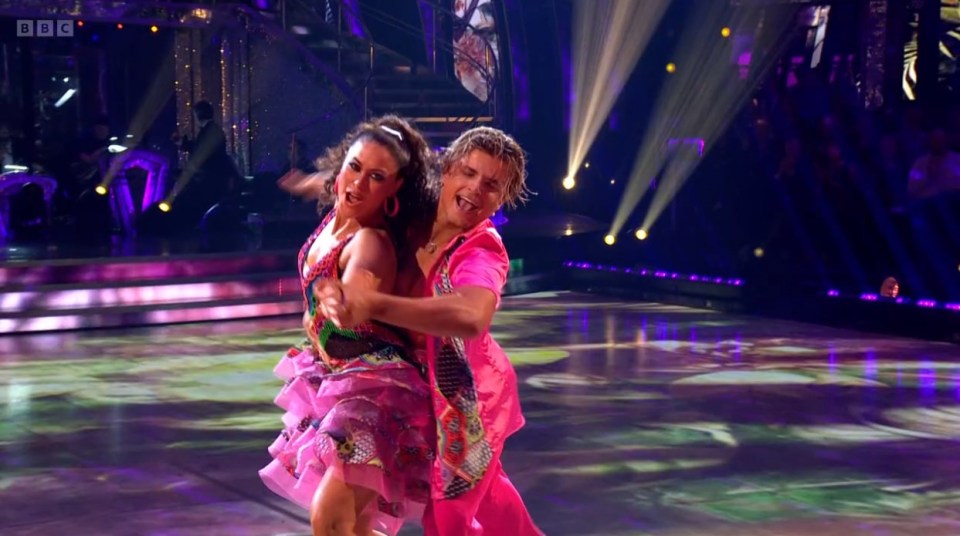 a man and a woman are dancing on a stage with bbc written on the bottom