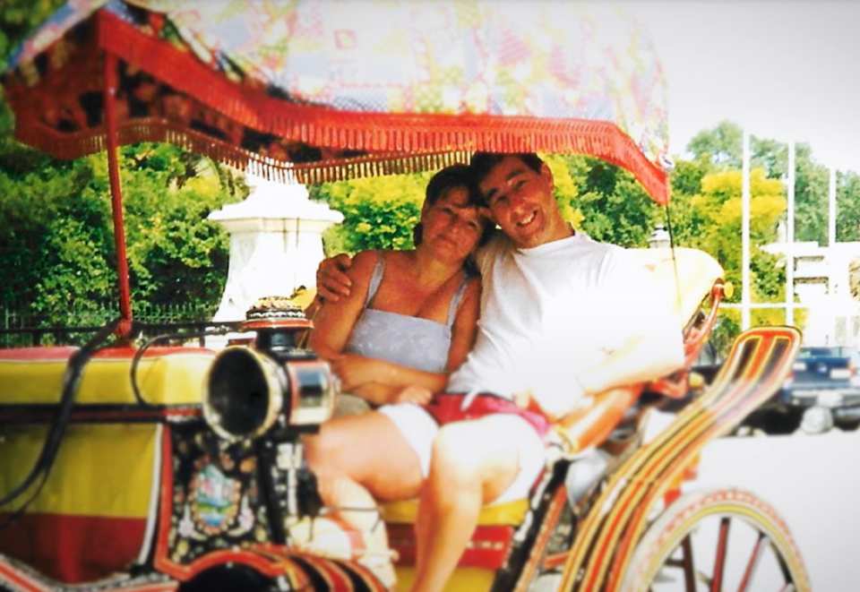 a man and a woman are sitting in a horse drawn carriage